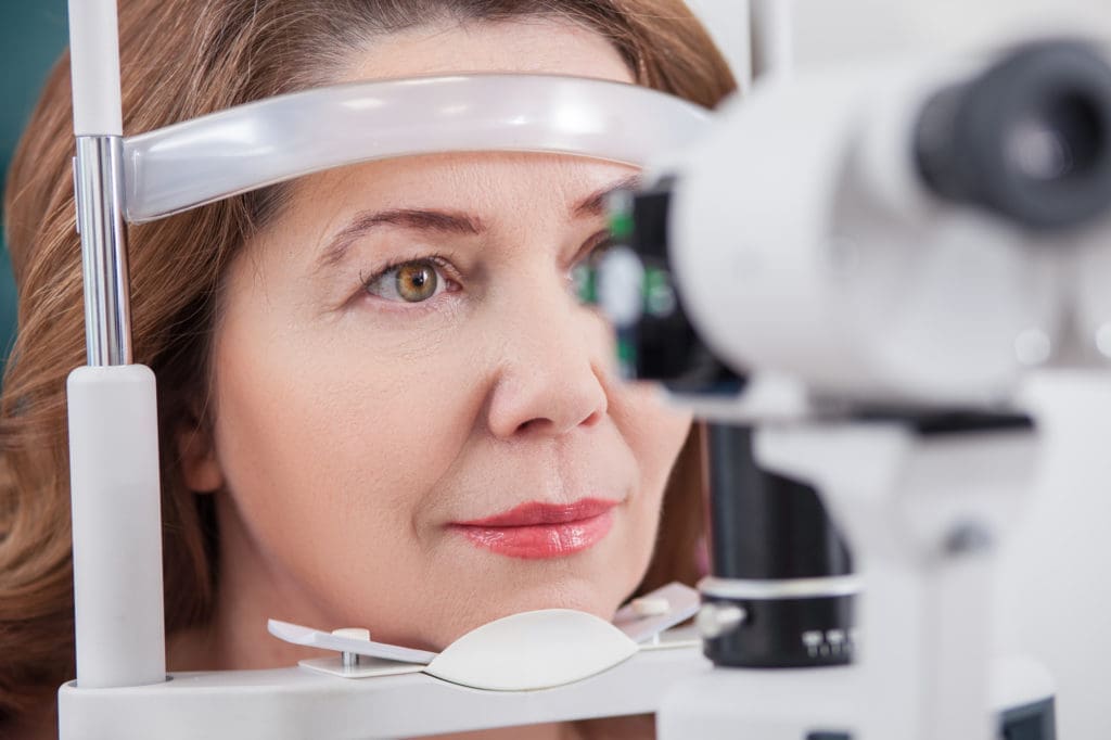 A woman is looking at eye exams.