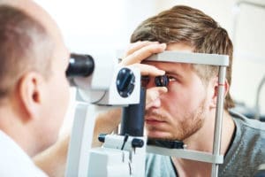 optometrist checking his client's eyes