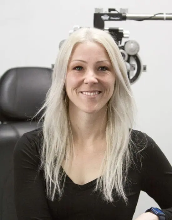 Woman smiling in an optometrist's management team office.