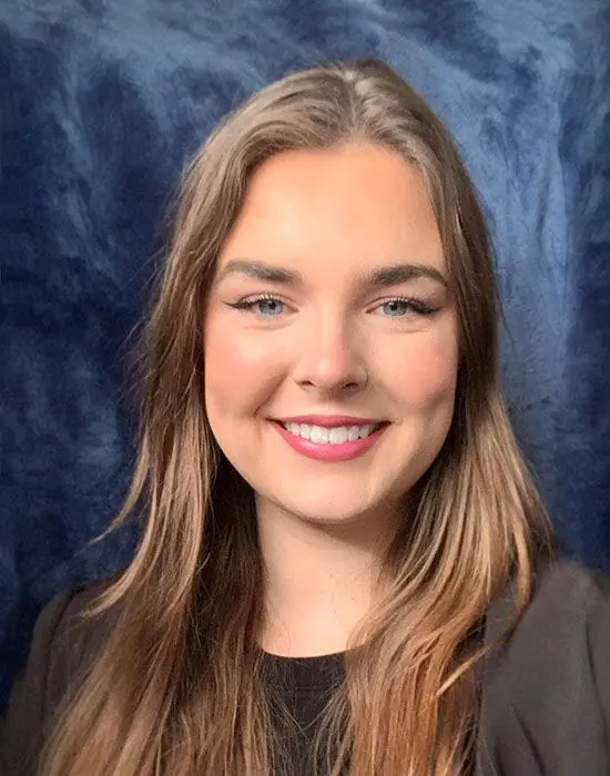 A smiling woman with long hair against a blue textured background offers administrative services.