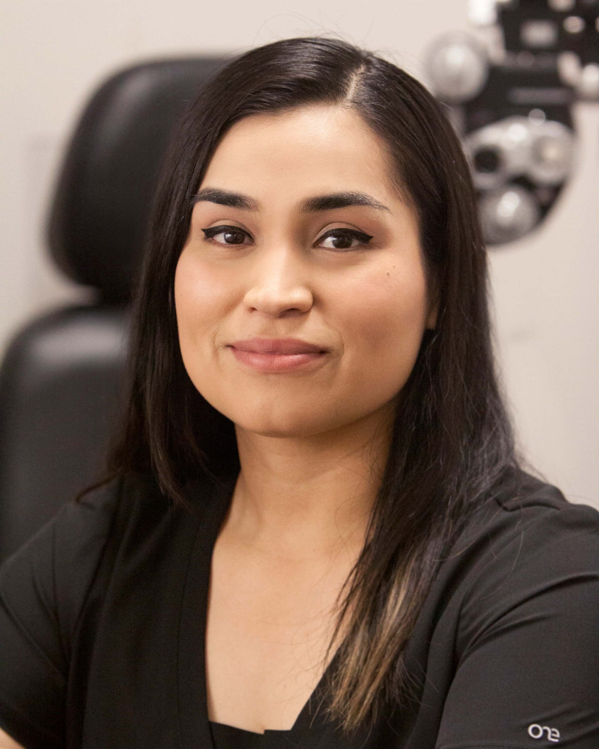 A woman in a black shirt, an optometrist in Twin Falls, sitting in an office.