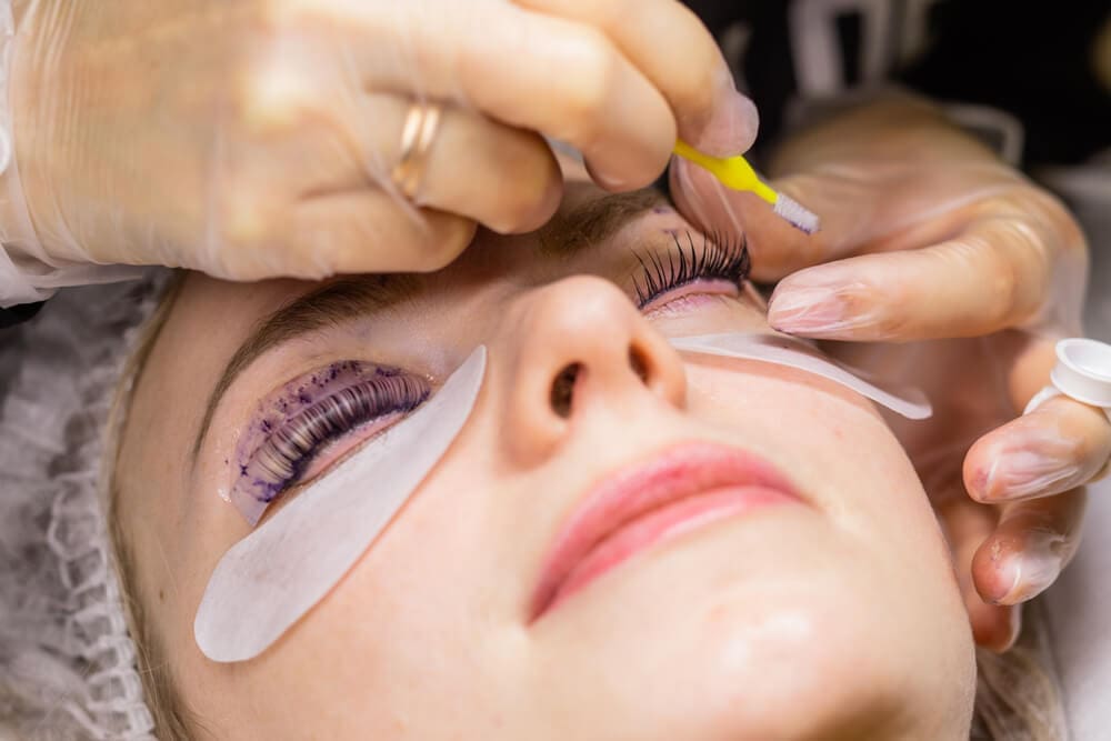 Application of eyelash extensions and Latisse treatments at a beauty salon.