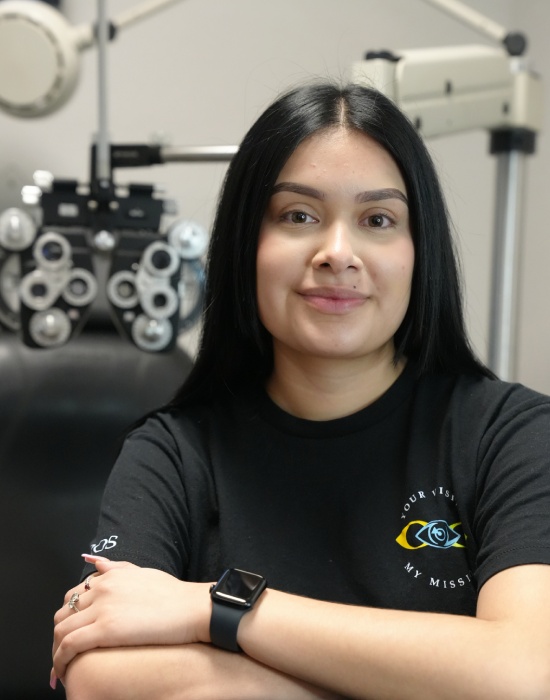 Woman in black t-shirt sitting in front of an optometrist's phoropter at Optometrist Nampa.