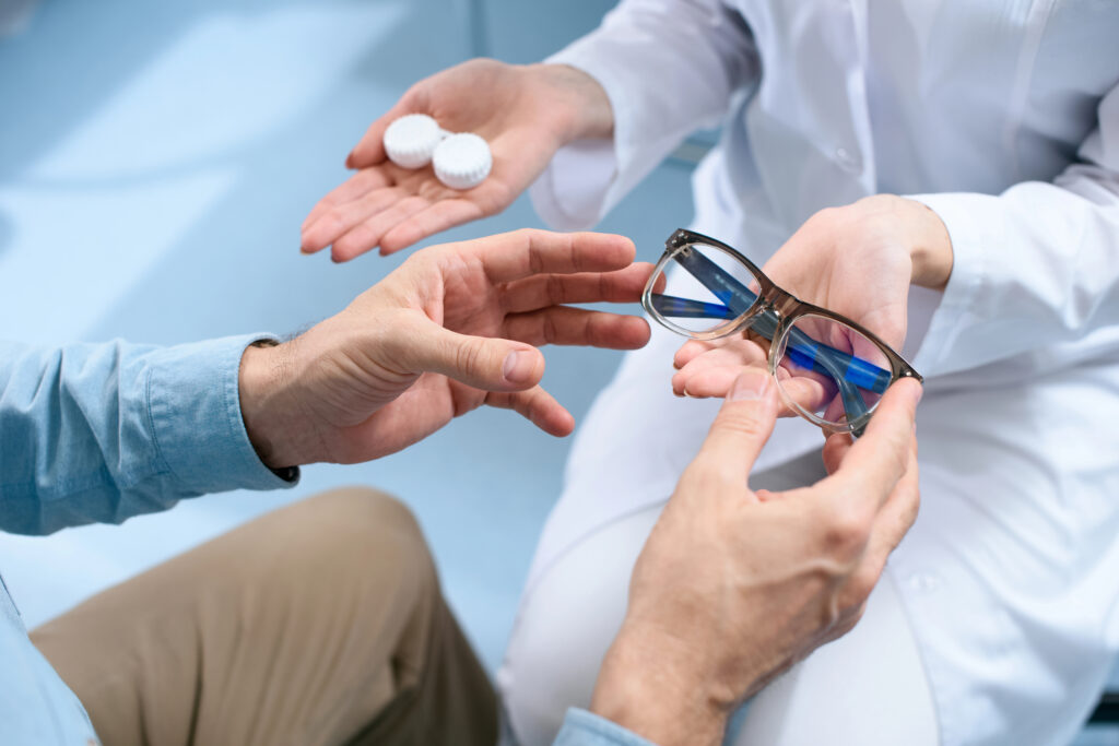 A patient choosing between contact lenses and blue light glasses during an eye care consultation at The Eye Pros. Expert guidance for better vision.