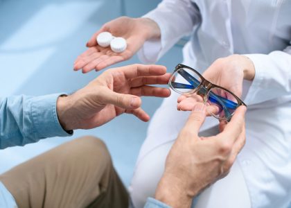 A patient choosing between contact lenses and blue light glasses during an eye care consultation at The Eye Pros. Expert guidance for better vision.
