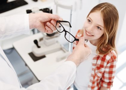 A young girl is getting her eyeglasses checked by the best optometrist.