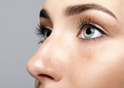 A close up of a woman's face highlighting eye vitamins.