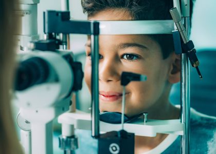 A young boy is looking at a medical eye exam.