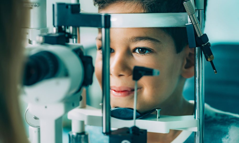 A young boy is looking at a medical eye exam.