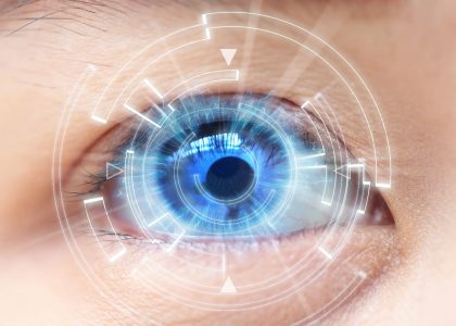 A person's eye with a blue light in it from sleeping in contacts.