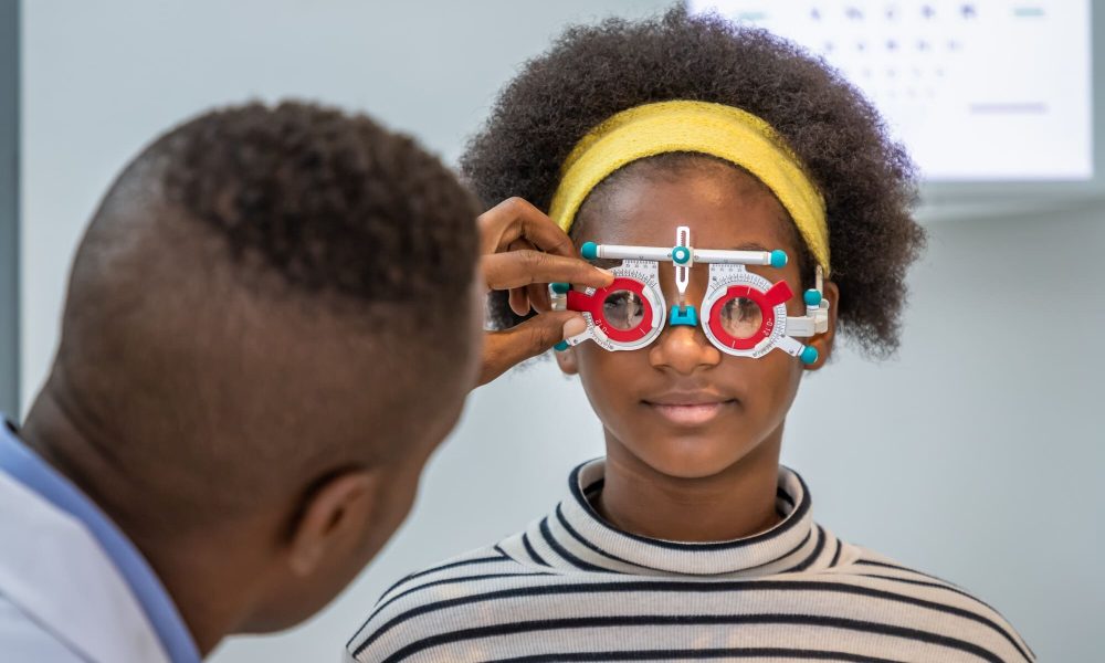 A young woman is being examined by an optometrist for the difference between nearsightedness and farsightedness.