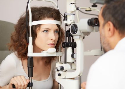 A woman is undergoing an eye exam in Boise by an optometrist.