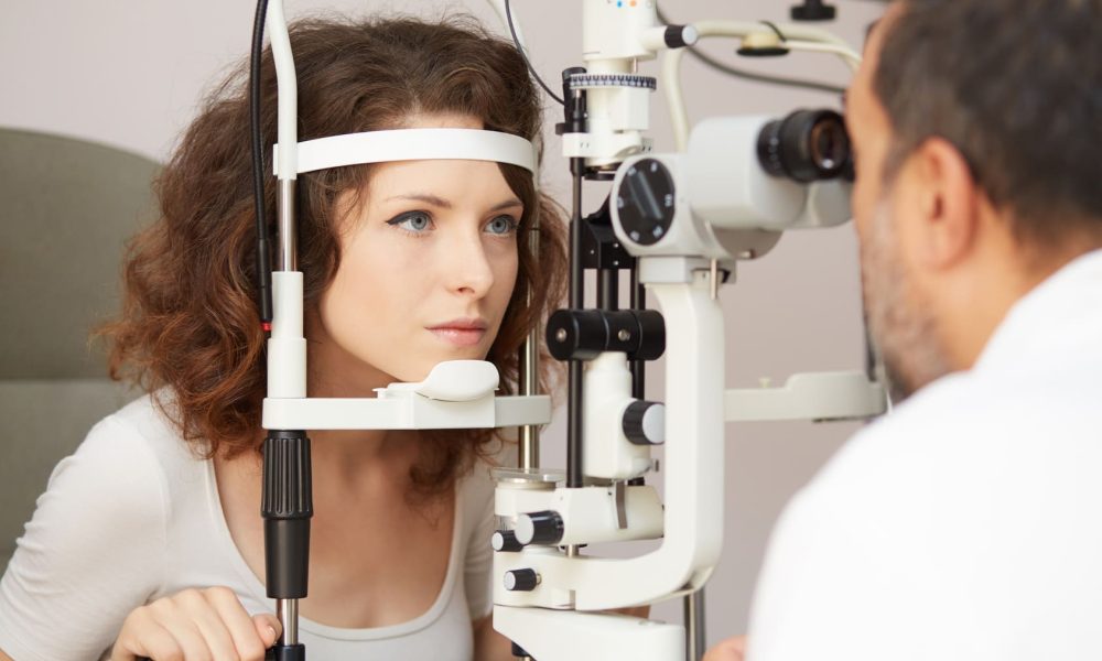 A woman is undergoing an eye exam in Boise by an optometrist.